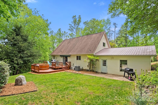 84 Varnadore Dr, Arden, NC 28704 - rear view of house with a wooden deck, a patio area, a lawn, and a metal roof