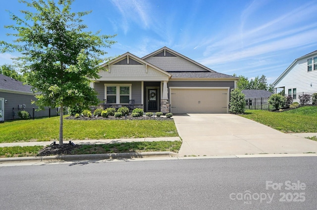 craftsman-style house with an attached garage, driveway, a porch, and stone siding
