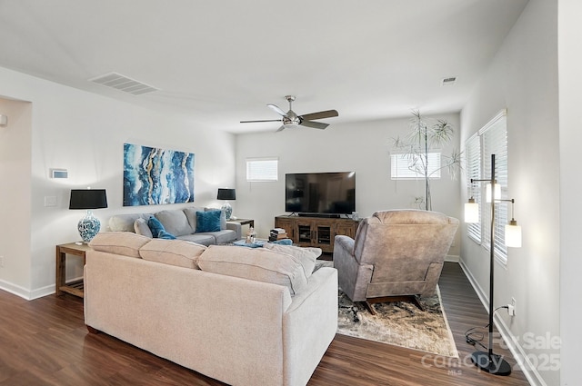 living room featuring dark wood finished floors, a ceiling fan, and baseboards