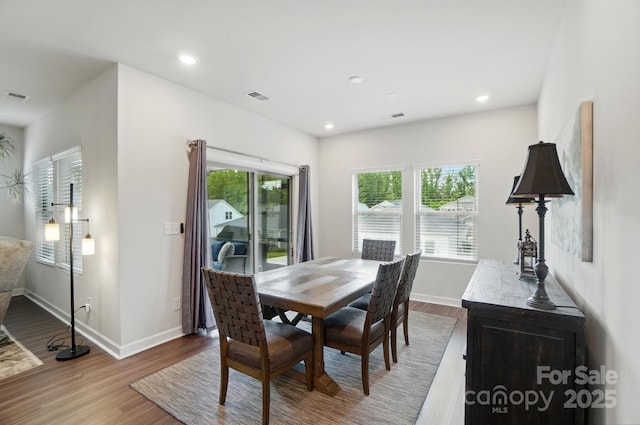 dining room with wood finished floors, baseboards, and recessed lighting