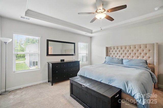 bedroom with a raised ceiling, ornamental molding, baseboards, and light colored carpet