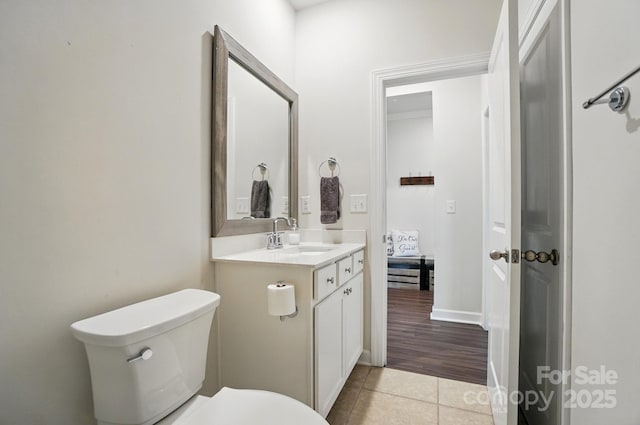 bathroom with tile patterned flooring, toilet, and vanity