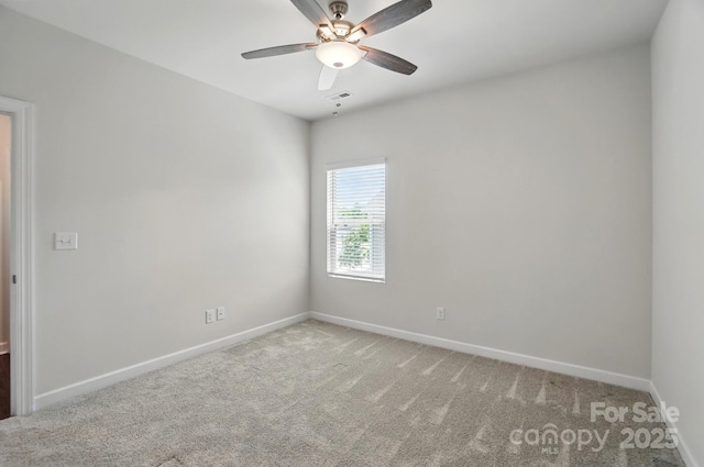 empty room featuring carpet floors, baseboards, and a ceiling fan