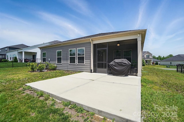 back of property with a sunroom and a patio area
