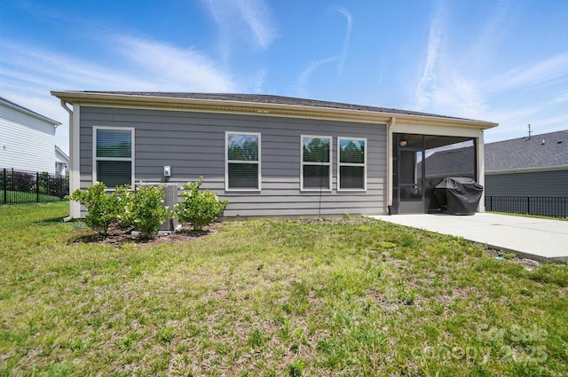 rear view of property with a sunroom, a patio area, and central AC unit
