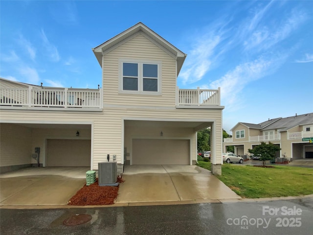 4105 Galloway Park Dr, Charlotte, NC 28262 - view of front facade with a balcony, a garage, central AC, a front lawn, and concrete driveway