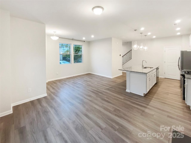 4105 Galloway Park Dr, Charlotte, NC 28262 - kitchen with a sink, recessed lighting, white cabinets, an island with sink, and wood finished floors