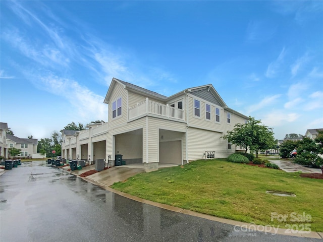 4105 Galloway Park Dr, Charlotte, NC 28262 - view of home's exterior featuring a balcony, a garage, central AC unit, and a lawn