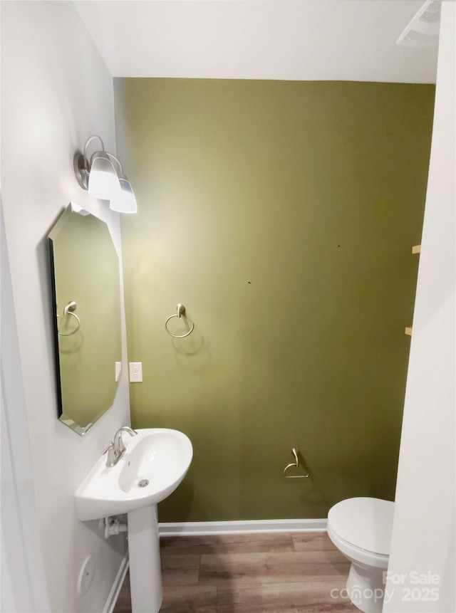 4105 Galloway Park Dr, Charlotte, NC 28262 - bathroom with baseboards, wood finished floors, and toilet