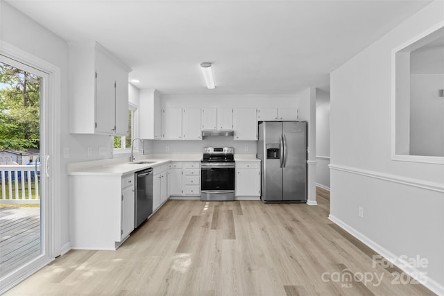 6412 Sullins Rd, Charlotte, NC 28214 - kitchen featuring stainless steel appliances, a sink, light wood-type flooring, light countertops, and under cabinet range hood