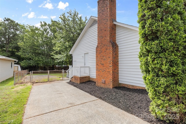6412 Sullins Rd, Charlotte, NC 28214 - view of home's exterior featuring a chimney and a gate