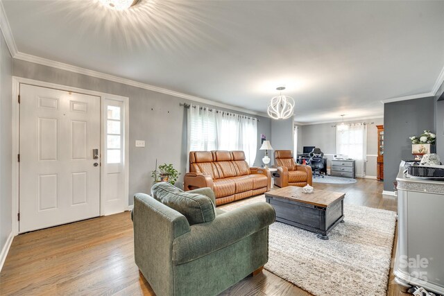 622 University Dr, Rock Hill, SC 29730 - living area with crown molding, a chandelier, light wood-style floors, and baseboards