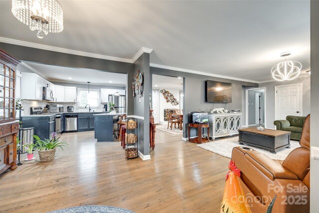 622 University Dr, Rock Hill, SC 29730 - living area featuring a chandelier, light wood-style flooring, ornamental molding, and baseboards