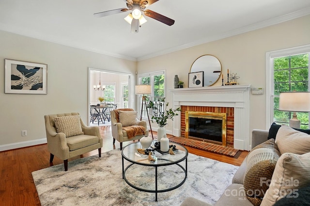 2725 Cotton Planter Ln, Charlotte, NC 28270 - living area with ornamental molding, wood finished floors, a ceiling fan, baseboards, and a brick fireplace