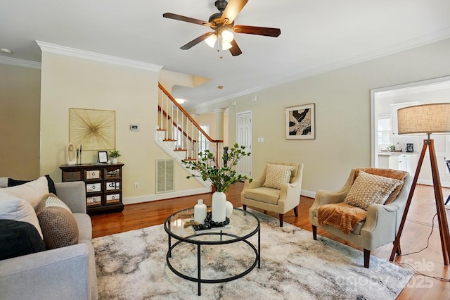 2725 Cotton Planter Ln, Charlotte, NC 28270 - living area with ornamental molding, stairway, ceiling fan, baseboards, and wood finished floors