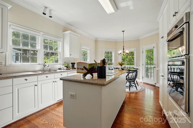 2725 Cotton Planter Ln, Charlotte, NC 28270 - kitchen featuring light wood-style flooring, a center island, a chandelier, double oven, and white cabinets