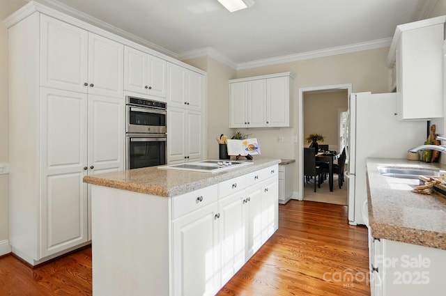 2725 Cotton Planter Ln, Charlotte, NC 28270 - kitchen featuring stainless steel double oven, white stovetop, ornamental molding, white cabinetry, and a sink