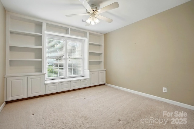 2725 Cotton Planter Ln, Charlotte, NC 28270 - spare room featuring baseboards, light carpet, a ceiling fan, and built in features