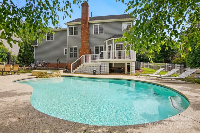 2725 Cotton Planter Ln, Charlotte, NC 28270 - view of pool with stairway, a patio area, a pool with connected hot tub, a wooden deck, and central air condition unit