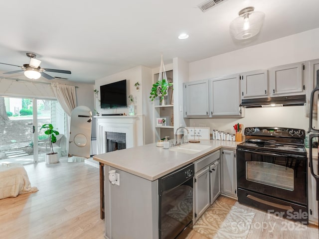 3308 Selwyn Farms Ln Unit 2, Charlotte, NC 28209 - kitchen with black appliances, a sink, under cabinet range hood, gray cabinetry, and open floor plan