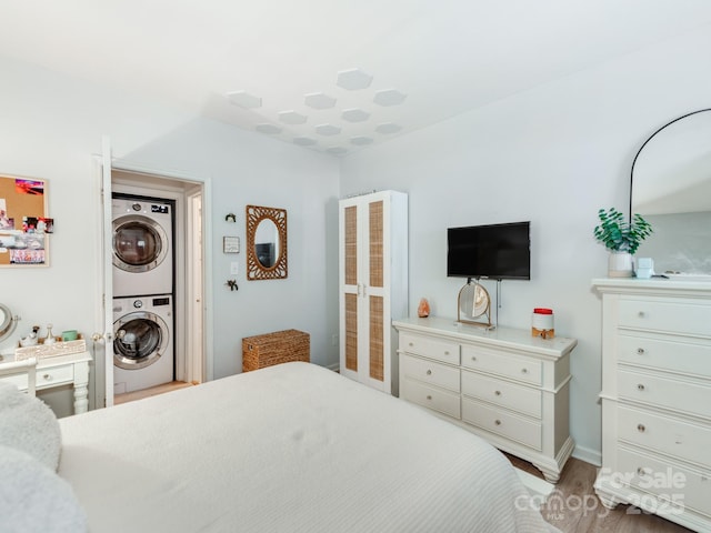 3308 Selwyn Farms Ln Unit 2, Charlotte, NC 28209 - bedroom featuring stacked washer / drying machine, wood finished floors, and baseboards
