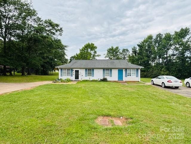 ranch-style house with driveway and a front yard