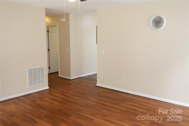 unfurnished room featuring wood finished floors, baseboards, and a ceiling fan
