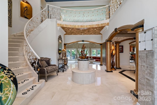 2971 Kaneland Ct, Rock Hill, SC 29732 - foyer entrance with decorative columns, crown molding, arched walkways, stairs, and a high ceiling