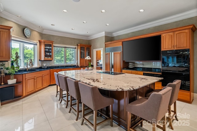2971 Kaneland Ct, Rock Hill, SC 29732 - kitchen featuring black appliances, a kitchen island, a kitchen breakfast bar, glass insert cabinets, and recessed lighting