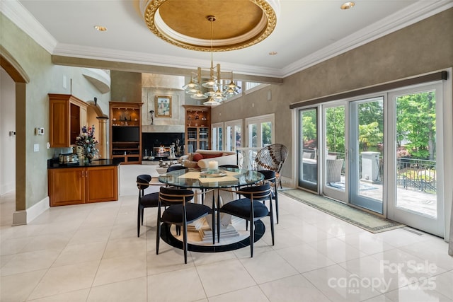2971 Kaneland Ct, Rock Hill, SC 29732 - dining area featuring arched walkways, a chandelier, light tile patterned flooring, ornamental molding, and a towering ceiling