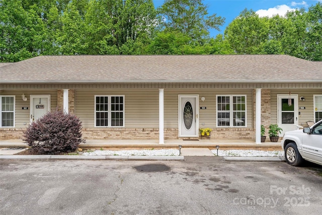 160 Whispering Pines Dr Unit 160, Marion, NC 28752 - view of front of home with brick siding, covered porch, and roof with shingles