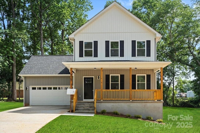 4541 Kings Ct, Hickory, NC 28602 - view of front of house featuring covered porch, an attached garage, a shingled roof, a front lawn, and board and batten siding