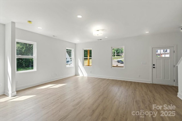4541 Kings Ct, Hickory, NC 28602 - unfurnished living room featuring light wood-style flooring, baseboards, and recessed lighting