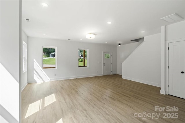 4541 Kings Ct, Hickory, NC 28602 - unfurnished living room with plenty of natural light, recessed lighting, wood finished floors, stairs, and baseboards