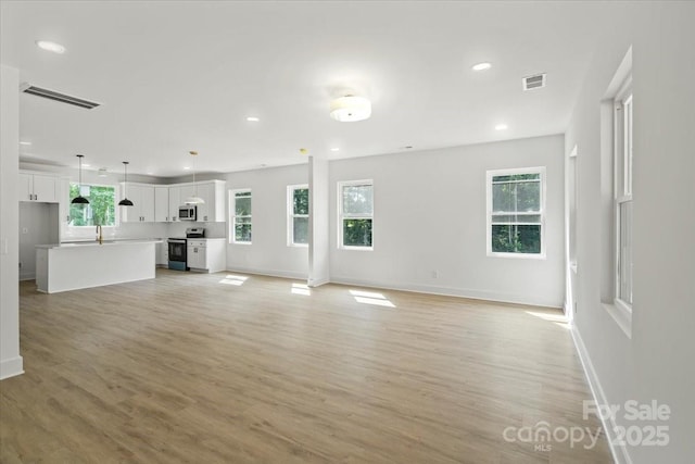 4541 Kings Ct, Hickory, NC 28602 - unfurnished living room with light wood-type flooring, baseboards, and recessed lighting