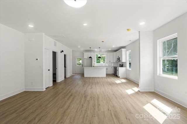 4541 Kings Ct, Hickory, NC 28602 - unfurnished living room featuring baseboards, recessed lighting, and light wood-style flooring