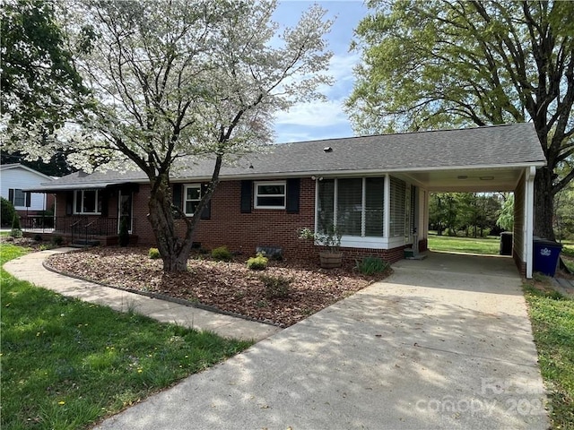 4200 Glenn Hi Rd, Winston Salem, NC 27107 - ranch-style home featuring concrete driveway, an attached carport, brick siding, a shingled roof, and crawl space