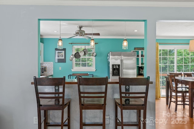 27 Dixon Ter, Candler, NC 28715 - kitchen with stainless steel refrigerator with ice dispenser, healthy amount of natural light, ceiling fan, crown molding, and decorative light fixtures