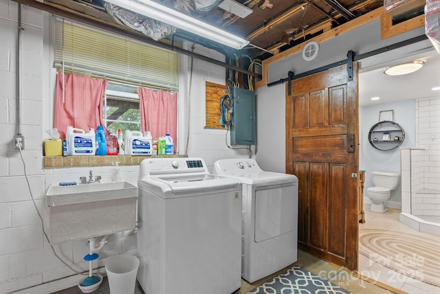 27 Dixon Ter, Candler, NC 28715 - laundry room featuring electric panel, separate washer and dryer, concrete block wall, and a barn door