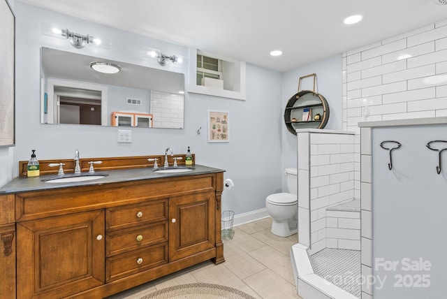 27 Dixon Ter, Candler, NC 28715 - bathroom featuring double vanity, tiled shower, tile patterned flooring, and recessed lighting