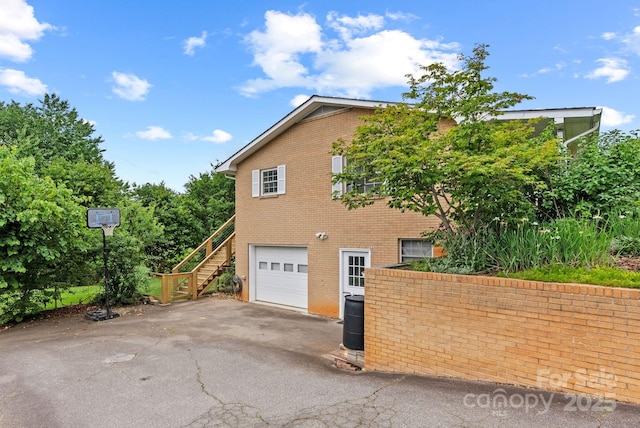 27 Dixon Ter, Candler, NC 28715 - view of home's exterior with stairway, driveway, brick siding, and an attached garage