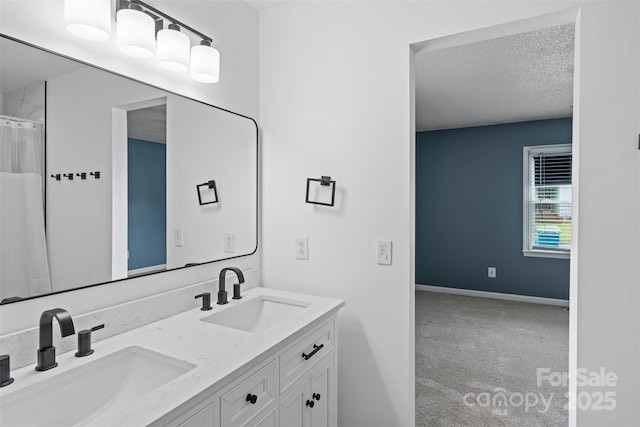 3103 Suggs St, Belmont, NC 28012 - bathroom with double vanity, a textured ceiling, and baseboards