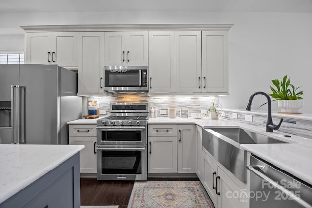 15913 Trenton Place Rd, Huntersville, NC 28078 - kitchen with stainless steel appliances, a sink, decorative backsplash, dark wood-type flooring, and light stone countertops