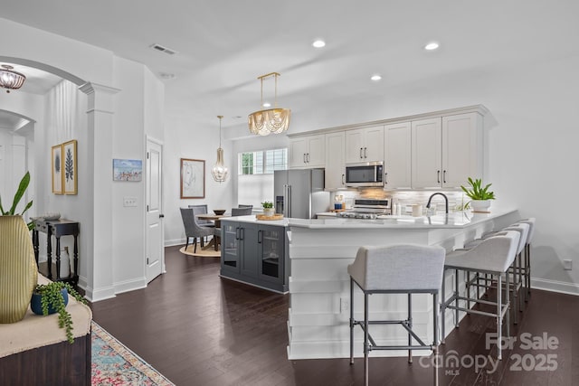 15913 Trenton Place Rd, Huntersville, NC 28078 - kitchen with appliances with stainless steel finishes, arched walkways, light countertops, baseboards, and recessed lighting