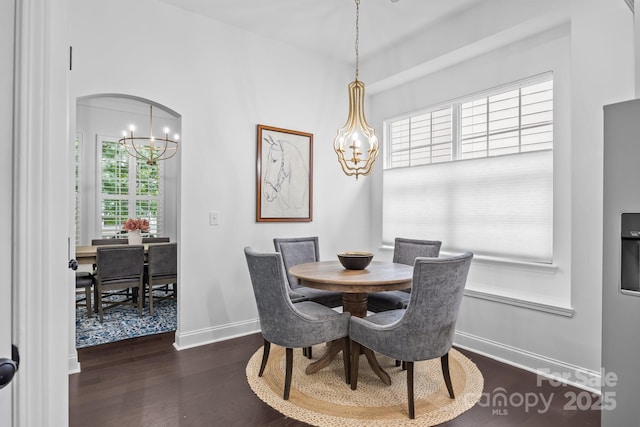 15913 Trenton Place Rd, Huntersville, NC 28078 - dining area featuring a chandelier, baseboards, dark wood-style flooring, and arched walkways