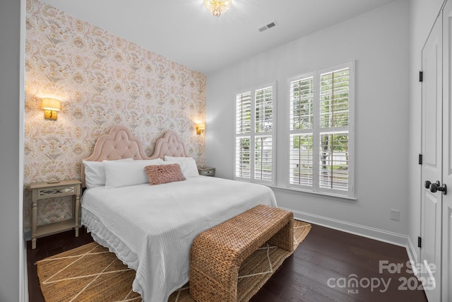 15913 Trenton Place Rd, Huntersville, NC 28078 - bedroom featuring wallpapered walls, baseboards, an accent wall, and wood finished floors