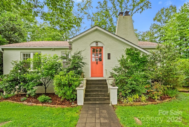 160 Hidden Hill Rd, Tryon, NC 28782 - view of front of home with a chimney, a front lawn, roof with shingles, and entry steps