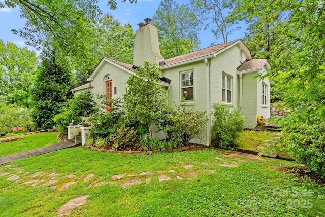 160 Hidden Hill Rd, Tryon, NC 28782 - view of side of home featuring a chimney and a yard