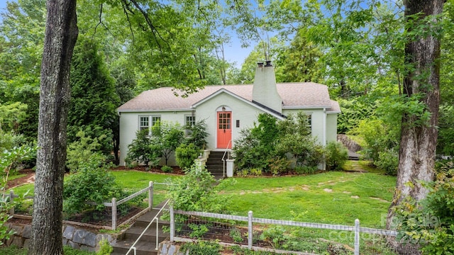 160 Hidden Hill Rd, Tryon, NC 28782 - view of front of house featuring a garden, a chimney, stucco siding, and a shingled roof