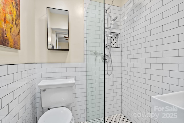 160 Hidden Hill Rd, Tryon, NC 28782 - full bathroom with walk in shower, tile walls, toilet, and a wainscoted wall